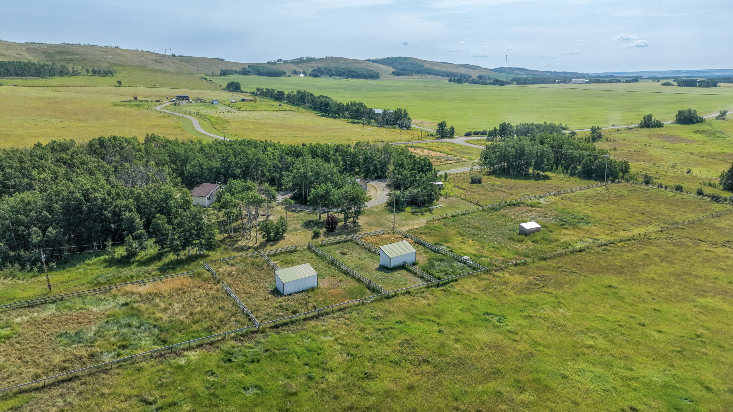 Horse paddocks and shelters on Foothills County acreage