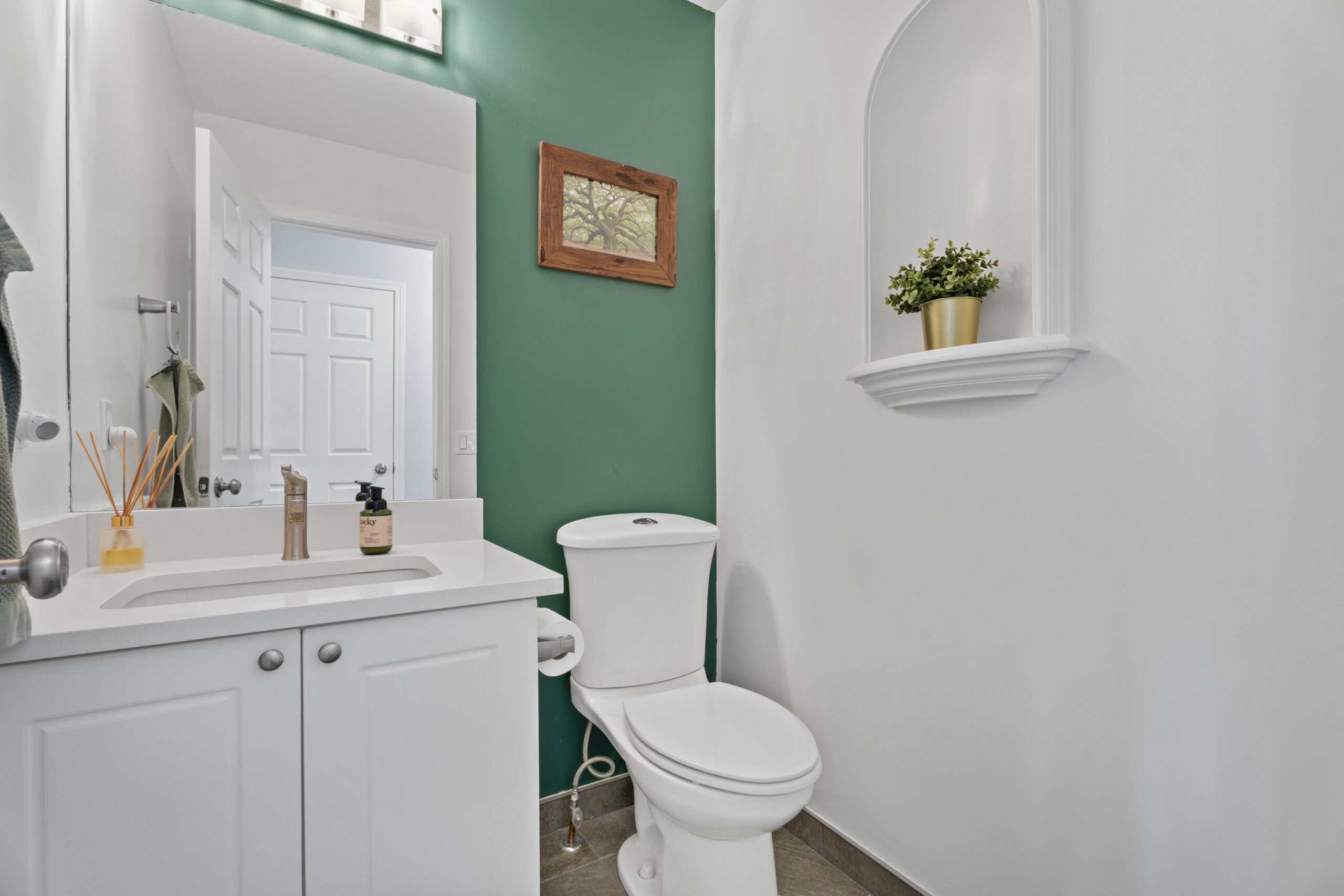 Half bath tucked away for privacy